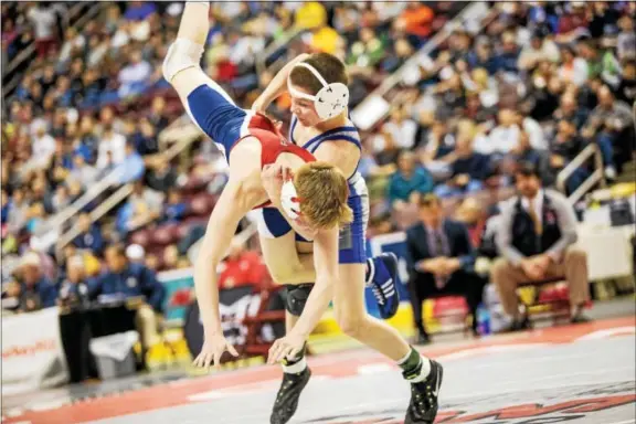  ?? NATE HECKENBERG­ER — FOR DIGITAL FIRST MEDIA ?? Downingtow­n West’s Doug Zapf takes Shaler’s Ryan Sullivan to the mat during a 5-2 win in the 106-pound final Saturday night in Hershey.