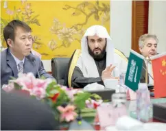  ??  ?? Saudi Justice Minister Walid Al-Samaani, center, speaks during a meeting with Zhang Jun, the Chinese justice minister, left, in Beijing on Tuesday. (SPA)