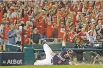  ?? JEFF ROBERSON/ASSOCIATED PRESS ?? The Nationals’ Adam Eaton scores on a hit by Anthony Rendon during the third inning.