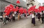  ?? AP ?? Anti-coup protesters prepare to release balloons attached to leaflets bearing various messages during a gathering in Yangon, Myanmar, on Wednesday. Hundreds of people who were imprisoned for protesting last month’s coup are being released as the military tries to placate the protest movement.