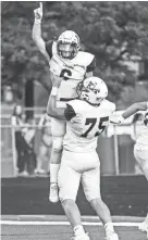  ?? GROUP SCOTT ASH / NOW NEWS ?? Kettle Moraine receiver Will Knutson celebrates his 46-yard touchdown reception with lineman Jacob Rock during the first quarter at Waukesha West on Friday.