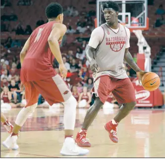  ?? NWA Democrat-Gazette/ANDY SHUPE ?? Arkansas guard Jaylen Barford (right) looks to drive around guard Jalen Harris on Oct. 20 during the annual Red-White game in Bud Walton Arena.