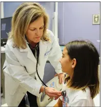  ?? Arkansas Democrat-Gazette/THOMAS METTHE ?? Dr. Stacie Jones examines peanut allergy sufferer Sarah Ella Han, 10, at Arkansas Children’s Hospital. “Many people with food allergy feel that much of the world is loaded with land mines for them,” Jones said.