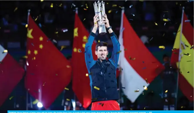  ??  ?? SHANGHAI: Novak Djokovic of Serbia poses with his trophy after beating Borna Coric of Croatia in their men’s singles final match at the Shanghai Masters tennis tournament yesterday. — AFP