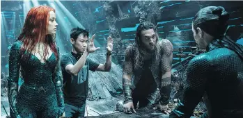  ??  ?? James Wan, centre, directs Amber Heard, left, Jason Momoa and Willem Dafoe on the set of Aquaman.