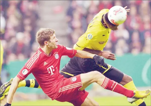  ??  ?? Munich’s Thomas Mueller, (left), challenges for the ball with Dortmund’s Felipe Santana during the German Soccer Cup (DFB Pokal) quarterfin­al match between FC Bayern Munich and Borussia
Dortmund in Munich, Germany, on Feb 27. (AP)