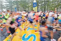  ?? MARY SCHWALM/ASSOCIATED PRESS FILE PHOTO ?? Runners cross the starting line during the 127th Boston Marathon last year in Hopkinton, Mass. Once a year for the last 100 years, the town kicks off the race.