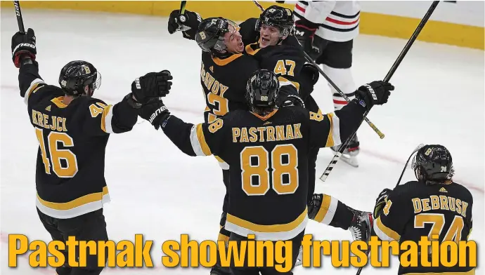  ?? MATT STONE / BOSTON HERALD ?? PASTA PROBLEMS: David Pastrnak celebrates a teammate’s goal Thursday. Despite his elation on this play, Pastrnak has been getting roughed up at a steadier clip of late as his offensive numbers continue to climb.