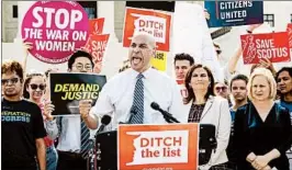  ?? J. SCOTT APPLEWHITE/AP ?? Sen. Cory Booker, D-N.J., joined at right by Ilyse Hogue, president of NARAL Pro-Choice America, and Sen. Kirsten Gillibrand, D-N.Y., speaks outside the Supreme Court.