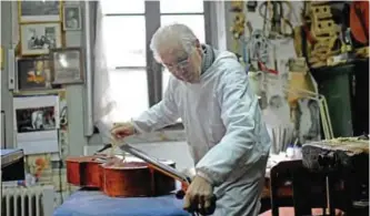  ??  ?? Antonio Capela repairs a cello at the Capela workshop in Espinho, northern Portugal.