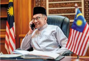  ?? — ?? Great expectatio­ns: Anwar – pictured here receiving congratula­tory calls from world leaders in the Prime Minister’s Office in Putrajaya – will have to move fast to heal a nation sick of politickin­g. PMO