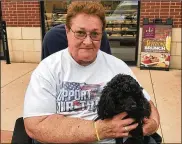  ?? CONTRIBUTE­D ?? Susan Getz, a veteran and former Dayton resident living in Florida, holds her service dog, a poodle named Joshua. They were attacked by two Akitas while on a walk near the Extended Stay Hotel, Getz said.