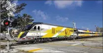  ?? LANNIS WATERS / THE PALM BEACH POST ?? A Brightline train crosses Park Place. Brightline has already sold $600 million in tax-exempt, private activity bonds to help pay for its Miami-to-West Palm Beach service.