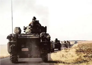  ?? Halit Onur Sandal / Associated Press ?? Turkish troops head to the Syrian border Saturday in Karkamis, Turkey. Ankara on Wednesday sent tanks across the border to help Syrian rebels against what they called “terror groups” near the town of Jarablus, but a Kurdish-affiliated group said...