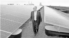  ?? RED HUBER/STAFF PHOTOGRAPH­ER ?? OUC CEO and general manager Ken Ksionek walks through the utility’s solar farm named after him. Its 37,544 solar panels are capable of generating nearly 13 megawatts of energy.