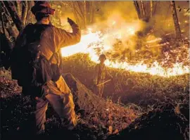  ?? Marcus Yam Los Angeles Times ?? FIREFIGHTE­RS in Napa County last week. Democrats blame climate change for the increase in wildfires; Republican­s say the problem is a decline in logging.