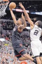  ?? ERIC GAY/ASSOCIATED PRESS ?? Houston forward Trevor Ariza drives past San Antonio’s Kawhi Leonard (2) during the Rockets’ win over the Spurs in Game 1 Monday.