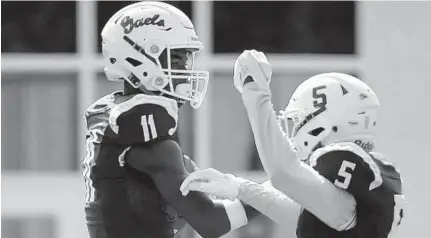  ?? KARL MERTON FERRON/BALTIMORE SUN ?? Mount St. Joseph’s Dont'e Thornton Jr, left, celebrates a touchdown reception against Calvert Hall during the 2018 season.