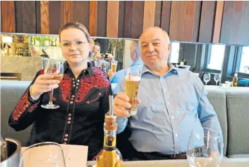  ??  ?? Sergei Skripal and Yulia, his daughter, enjoy a drink at a restaurant. The nerve agent attack on the pair led to parts of Salisbury city centre being cordoned off as experts, below, collected samples