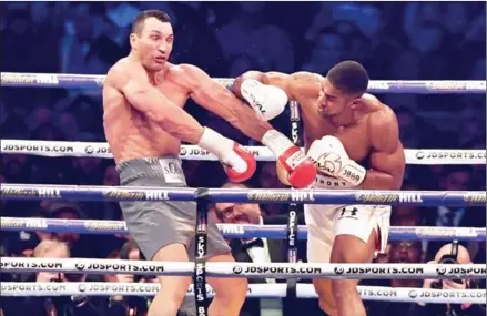  ?? BEN STANSALL/AFP ?? Anthony Joshua lands a punch on Wladimir Klitschko in the fourth round of their world heavyweigh­t title fight at Wembley Stadium in northwest London on Saturday.