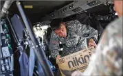  ?? DENNIS M. RIVERA PICHARDO / THE NEW YORK TIMES ?? Army personnel unload relief supplies Thursday in Cidra, Puerto Rico. President Donald Trump suggested again Thursday that Puerto Rico bore some of the blame for its current crisis.