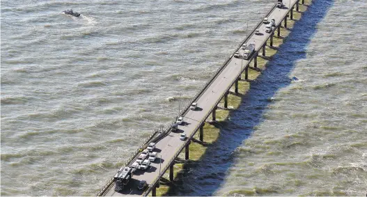  ?? JONATHON GRUENKE /STAFF ?? Police respond after a truck drove off the Chesapeake Bay Bridge-Tunnel Tuesday morning.