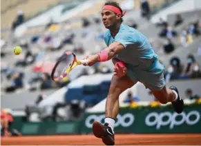  ??  ?? Going strong: Rafael Nadal makes a return to Mackenzie McDonald during their French Open second round match. — AFP