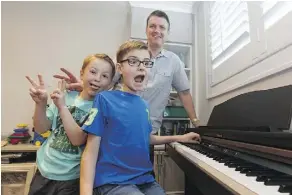  ?? IAN KUCERAK ?? From left, Parker, Erick and dad Mike Seed, 50, all take lessons at Backbeat, a music school on Whyte Avenue.