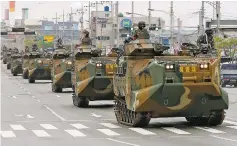  ?? YONHAP VIA AP FILE ?? South Korean Marines move amphibious assault vehicles after attending joint military drills with the U.S. in April in Pohang, South Korea. President Donald Trump’s offer to call off such exercises was seen as a major concession to North Korea and a...