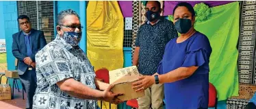  ?? Photo: Sampras Anand ?? Head teacher of Korokadi Primary School, Sanjay Kumar receive boxes of masks and hand sanitizers from the Minister for Education, Heritage and Arts, Premila Kumar at Lekutu Secondary School.