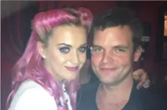  ?? ?? Mr Harding, who lives in Ashford, with singer Katy Perry at a private party