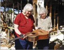  ?? PHOTOS BY SHAE HAMMOND — STAFF PHOTOGRAPH­ER ?? Musicians Jane Silver and Elaine Miller on April 1 hold one of their guitars that was destroyed when their home at River Glen Mobile Home Park in San Jose last month.