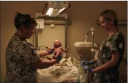  ?? LIBKOS/ASSOCIATED PRESS ?? A medic holds a newborn baby in a city hospital in Mykolaiv, the site of heavy battles with Russian forces, Ukraine, Thursday, Nov. 3, 2022.