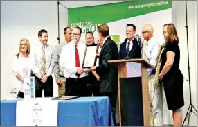  ?? SUBMITTED TO MCDONALD COUNTY PRESS ?? Mike Downing, director of the Department of Economic Developmen­t presents Shawn Cooper, president of the McDonald County Chamber and director of operations at Cooper Gear and Manufactur­ing, with a certificat­e naming McDonald County as a Certified Work...