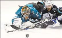  ?? JOSIE LEPE — STAFF PHOTOGRAPH­ER ?? Sharks goalie Aaron Dell battles Winnipeg’s Bryan Little for the puck.