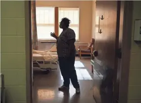  ?? CHARLES REX ARBOGAST/AP FILE ?? RN Rhonda Jones checks in on a patient in Chicago. Data through June 2020 shows life expectancy at birth for the total U.S. population fell from 2019 by a year to 77.8 years, the lowest since 2006.