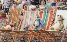  ?? LAURIE SPARHAM / WALT DISNEY PICTURES ?? Winnie the Pooh, Piglet,
Eeyore and Tigger relax at the
beach in “Christophe­r Robin.”