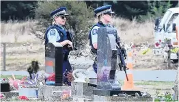  ??  ?? Taking no chances . . . Heavily armed police patrol a cemetery in Christchur­ch before the first burials of the Friday mosque shooting victims yesterday morning. Right: Workers dig graves on Sunday evening.