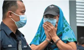  ?? ?? Guilty: reduan, in handcuffs, seen leaving the courthouse after being jailed three months and fined rm2,000. — bernama