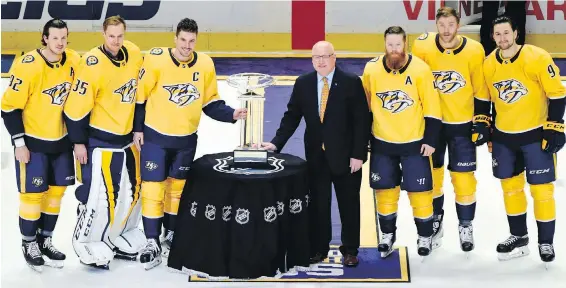  ?? MARK ZALESKI, THE ASSOCIATED PRESS ?? Nashville Predators captain Roman Josi is presented the Presidents’ Trophy by NHL deputy commission­er Bill Daly.