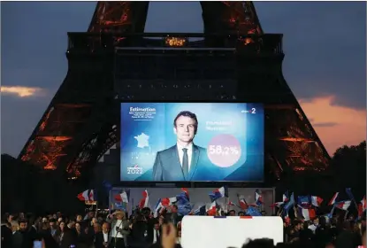  ?? GAO JING / XINHUA ?? People gather at a rally in Paris on April 24 for French President Emmanuel Macron after the presidenti­al runoff. Macron won reelection with 58.54 percent of the votes.