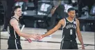  ?? ASHLEY LANDIS — THE ASSOCIATED PRESS ?? Brooklyn’s Timothe LuwawuCaba­rrot (9) and Rodions Kurucs (00) walk off the court for halftime against Milwaukee on Tuesday in Lake Buena Vista, Fla.