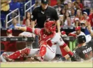  ?? WILFREDO LEE — THE ASSOCIATED PRESS ?? Martin Prado scores past the attempted tag by Phillies catcher Cameron Rupp on a single by Giancarlo Stanton in the sixth inning of the Marlins’ 5-0 win Tuesday.