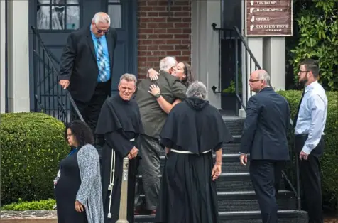  ?? Michael M. Santiago/Post-Gazette ?? Mourners embrace as they arrive Saturday in Washington, Pa., for the funeral of Nicholas Cumer, who was killed in the Aug. 4 mass shooting in Dayton, Ohio.