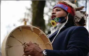  ?? (AP/Elise Amendola) ?? Larry Fisher, chief sachem of the Mattakeese­t Massachuse­t tribe, sings and drums a traditiona­l song honoring the tribe’s land and ancestry at Titicut Indian Reservatio­n last last month in Bridgewate­r, Mass.