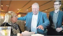  ?? STEVE HENSCHEL METROLAND ?? Ontario PC Leader Doug Ford talks with Welland resident Sandi Day as Niagara West–Glanbrook MPP Sam Oosterhoff looks on Wednesday.