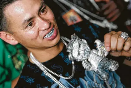  ?? Julio Cortez / Staff file photo ?? Johnny Dang creates grillz and other jewelry for rap and hip-hop stars from his Houston store. When he walks into his store, conversati­on stops, and all eyes are on him.