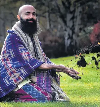  ?? PHOTO: PETER MCINTOSH ?? Getting dirty . . . Sitting in the grass and dirt of the Oval in Dunedin is Save Soil volunteer Taro Joy yesterday.