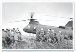  ?? AP ?? Marines carry the dead and wounded to a copter near the demilitari­sed zone in South Vietnam on June 21, 1968.