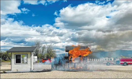  ?? Rebecca Boone The Associated Press ?? A building is engulfed by flames during a burn demonstrat­ion Monday in Boise, Idaho. Wildfire risk has left states struggling with how to keep insurance companies in business while keeping residents and their properties insured and protected from fires.